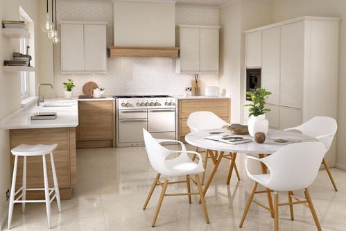 Image of a white and cream multifunctional kitchen design, featuring wooden kitchen units and marble countertops and surfaces