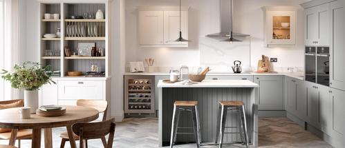 Image of an open-plan traditional kitchen design with integrated kitchen appliances and wooden furniture.