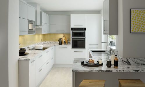 Image of a white modern kitchen design featuring white and grey kitchen units, integrated kitchen appliances, and white marble kitchen worktops.