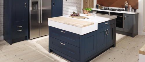 A classic Mornington shaker in Ives blue and inkwell with white worktop and kitchen island.