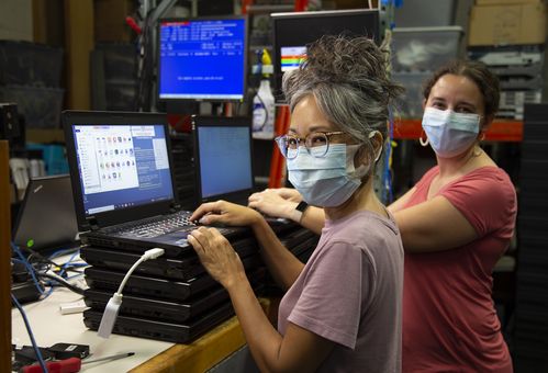 two women fixing computeres