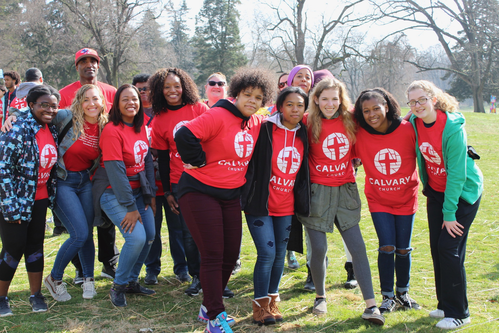 Group of people in matching Calvary shirts
